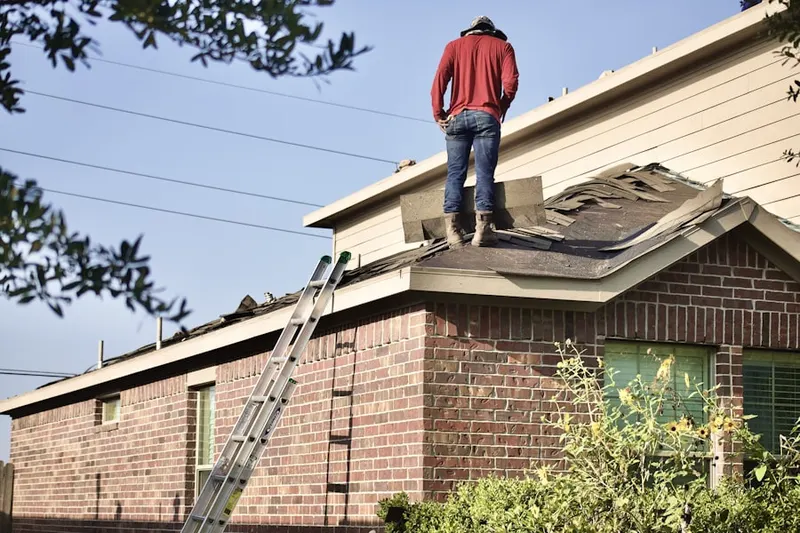 Professional roofer working on a residential roof in Technology Village